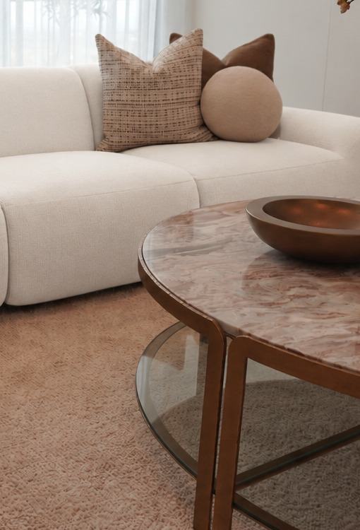 Detail of the Freya sofa, its soft boucle seat with layered scatter cushions